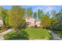 Inviting home with lush lawn, mature trees and classic architectural details at 9927 Clarkes View Nw Pl, Concord, NC 28027