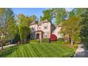 Beautiful home with pristine lawn, verdant landscaping, and classic façade at 9927 Clarkes View Nw Pl, Concord, NC 28027