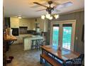 Cozy kitchen features an adjacent dining area, a breakfast bar, and backyard access at 1014 Stuart Dr, Wadesboro, NC 28170
