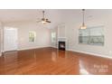 Bright living room boasts vaulted ceilings, fireplace, and ample natural light from large windows at 10318 Caldwell Depot Rd, Cornelius, NC 28031
