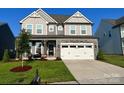 Charming two-story home with a well-manicured lawn and two-car garage at 1077 Hearth Sw Ln, Concord, NC 28025