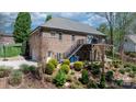 A spacious backyard featuring a deck, landscaping, and a brick exterior at 1158 Waterford Dr, Hickory, NC 28602