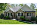 Charming brick home with manicured lawn, tasteful landscaping, and classic architectural details at 1158 Waterford Dr, Hickory, NC 28602