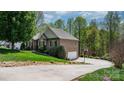 Brick house featuring a driveway, a garage and beautiful landscaping at 1158 Waterford Dr, Hickory, NC 28602