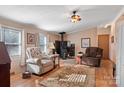 Cozy living room featuring a wood-burning stove and comfortable seating area with a ceiling fan at 119 Loray Ln, Statesville, NC 28625