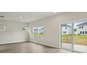 Bright living room with sliding glass door, three windows, and modern flooring at 1240 Morehead Dr, Salisbury, NC 28144