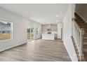 Open-concept living room with kitchen, staircase, and sliding glass door access to the backyard at 1240 Morehead Dr, Salisbury, NC 28144