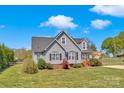Charming two-story home with manicured lawn, complemented by mature trees and landscaping at 126 Top Flite Dr, Statesville, NC 28677