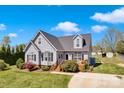 Attractive home with gray siding, a dark roof, and a beautifully landscaped front yard at 126 Top Flite Dr, Statesville, NC 28677