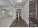 Inviting foyer with hardwood floors, elegant archways, and a view of the living and dining areas at 12710 Es Draper Dr, Huntersville, NC 28078
