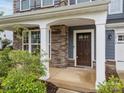 Welcoming front entrance featuring stone pillars and a classic brown front door at 12710 Es Draper Dr, Huntersville, NC 28078