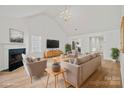 Bright living room with high ceilings, fireplace, and stylish furnishings at 1409 Rheo Nw Ct, Concord, NC 28027