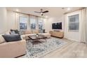 Bright living room with a large sectional sofa, stylish rug, and plenty of natural light at 15116 Caspian Way, Charlotte, NC 28278