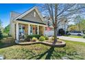 Beautiful home with manicured lawn, brick facade, and an American flag by the attached garage at 152 Blossom Ridge Dr, Mooresville, NC 28117