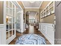 Elegant foyer featuring hardwood floors, wainscoting, and French doors, creating a grand entrance at 152 Blossom Ridge Dr, Mooresville, NC 28117