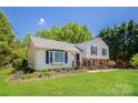 Charming home featuring manicured front lawn, beautiful landscaping, and a classic facade at 1637 Buckingham Ave, Gastonia, NC 28054