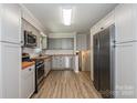Renovated kitchen featuring stainless steel appliances, wood countertops, and modern gray cabinetry at 1637 Buckingham Ave, Gastonia, NC 28054