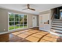 Sunlit living room featuring hardwood floors, a large window, and staircase access at 1766 Colony Rd, Rock Hill, SC 29730