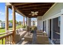 Inviting outdoor patio featuring stylish wicker furniture and a ceiling fan for relaxing and enjoying the views at 18700 Nautical Dr # 203, Cornelius, NC 28031