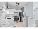 Well-lit kitchen with marble counters, tiled backsplash, and stainless steel appliances at 2059 Lennox Square Rd, Charlotte, NC 28210