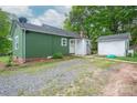 Backyard of house with gravel, detached garage, and green siding at 211 Hershel Lackey Rd, Lincolnton, NC 28092