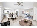 Bright, open-concept living room featuring modern decor and an adjacent dining area with a white and neutral color palette at 3804 Freedom Dr, Charlotte, NC 28208