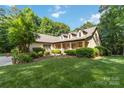 Inviting home with a manicured lawn and charming front porch, perfect for enjoying the outdoors at 4925 Pageland Hwy, Monroe, NC 28112