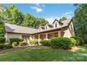 Charming home with a welcoming porch and lush landscaping, creating an inviting curb appeal at 4925 Pageland Hwy, Monroe, NC 28112