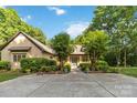 Beautiful home surrounded by lush trees and landscaping creating a private and inviting atmosphere at 4925 Pageland Hwy, Monroe, NC 28112