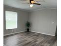 Cozy living room featuring modern gray flooring, neutral walls, and natural light from the window at 5767 Swinging Bridge Rd, Conover, NC 28613