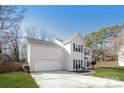 Side view of a two-story home featuring an attached two-car garage and a well-maintained lawn at 6111 Panache Dr, Matthews, NC 28104