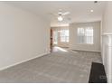 Bright living room with neutral carpet, a fireplace and an open view of the dining area at 6111 Panache Dr, Matthews, NC 28104