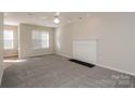 Comfortable living room with neutral carpet, a fireplace and a ceiling fan at 6111 Panache Dr, Matthews, NC 28104