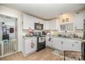 Updated kitchen with white cabinets, granite countertops, stainless steel appliances, and stylish backsplash at 705 Sumter St, Lancaster, SC 29720