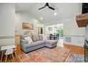 Open floor plan featuring a gray sofa, wood floors, and recessed lighting open to the dining room at 73 Wyth Sw Ct, Concord, NC 28025