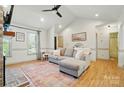 Bright living room featuring vaulted ceilings, gray sofa, and wood floors with a decorative rug at 73 Wyth Sw Ct, Concord, NC 28025