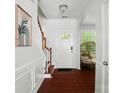 Bright foyer with hardwood floors, staircase, and modern decor at 8504 Sunset Hill Rd, Waxhaw, NC 28173