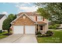 Charming two-story home featuring a stone accent facade and a two-car garage in a well-manicured neighborhood at 8604 Cedardale Ridge Ct, Charlotte, NC 28269