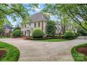 Stately home with a circular driveway and lush landscaping adding to its curb appeal at 8934 Winged Bourne Dr, Charlotte, NC 28210