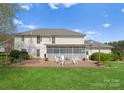 Backyard featuring a large deck with a fire pit and plenty of seating perfect for outdoor entertaining at 1052 Perth Rd, Troutman, NC 28166
