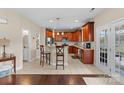 Open kitchen featuring granite counters, stainless appliances, a breakfast bar, and tiled floors at 1052 Perth Rd, Troutman, NC 28166