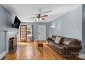 Bright living room with hardwood floors, fireplace, and access to the front yard at 1068 14Th Nw Ave, Hickory, NC 28601
