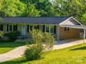 Traditional brick house with a spacious driveway, covered carport, and beautiful front yard landscaping at 1277 Rainbow Cir, Catawba, SC 29704