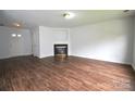 Spacious living room features wood-look flooring and fireplace, offering a cozy ambiance at 14608 Arlandes Dr, Charlotte, NC 28278