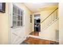 Bright entryway with hardwood floors and staircase leading to the upper level of the home at 147 Spring Shore Rd, Statesville, NC 28677