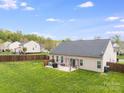 Spacious backyard featuring a well-maintained lawn and a cozy patio area, perfect for relaxation at 2077 Taney Way, Fort Mill, SC 29707