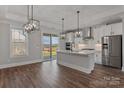 Modern kitchen with white cabinets, stainless steel appliances, island with sink, and hardwood flooring at 2093 Fordhill St, Rock Hill, SC 29732