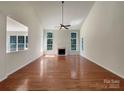 Bright living room features tall ceilings, gas fireplace, and beautiful hardwood floors at 2163 Woodstream Rd, Harrisburg, NC 28075