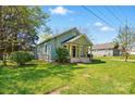 An exterior view showcasing the home's well-maintained lawn and surrounding greenery at 224 Adrian St, Mount Holly, NC 28120