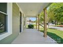 A look at the front porch with its wooden pillars and painted floors at 224 Adrian St, Mount Holly, NC 28120